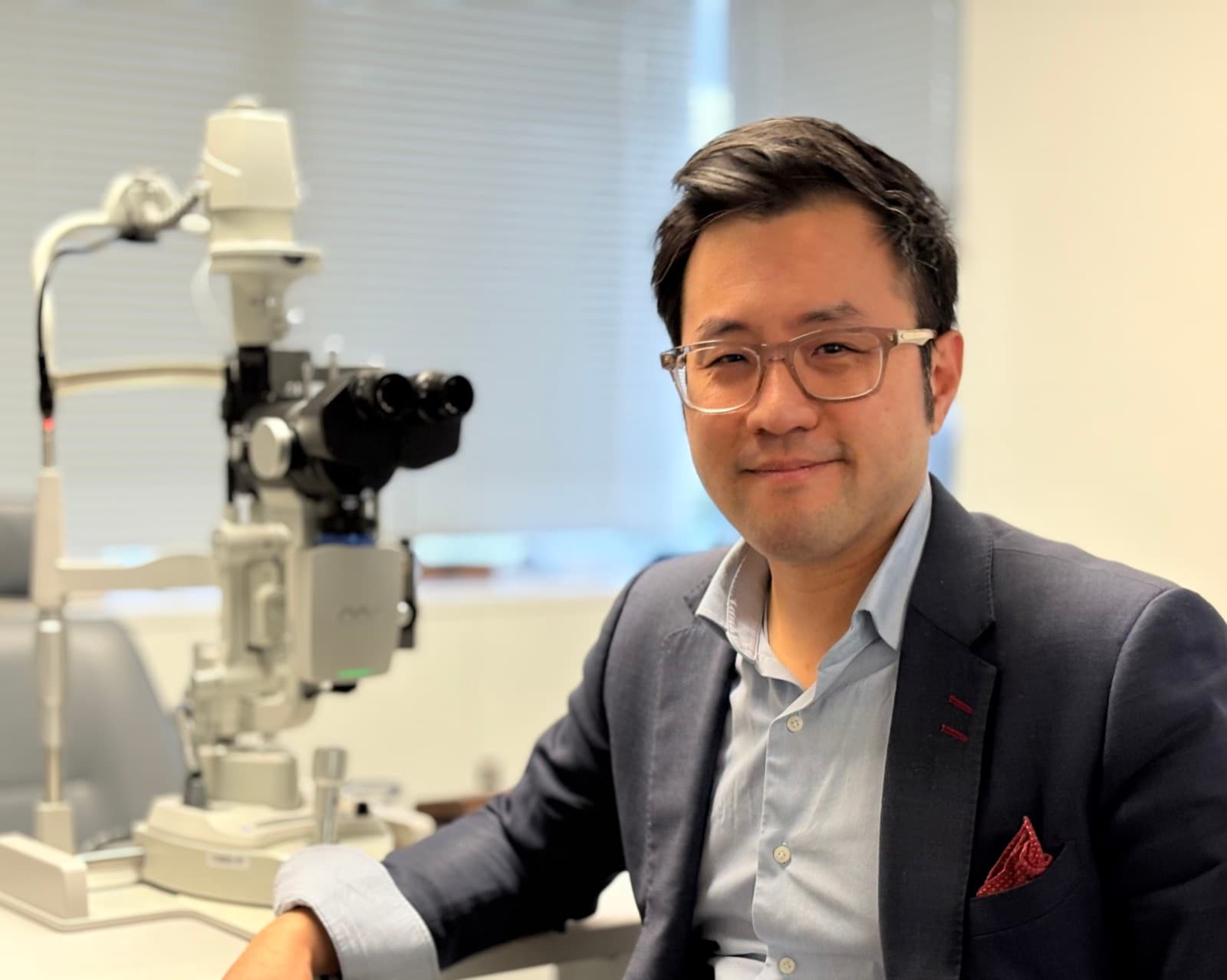 Dr James Leong beside the slit lamp at The Eye Clinic